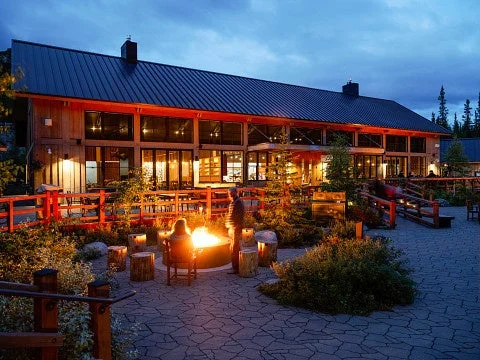 焚き火を囲む夜景のロッジ